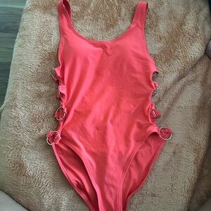 Size small one piece bathing suit with ringlets on the side